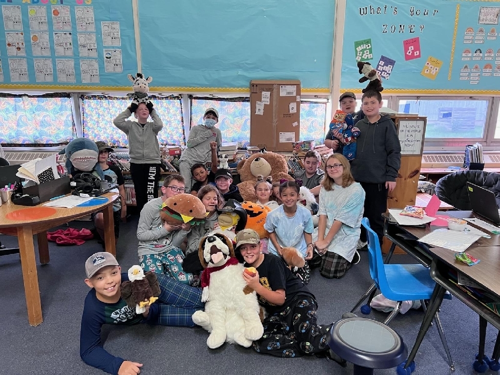 students in pajamas with stuffys in a classroom setting 