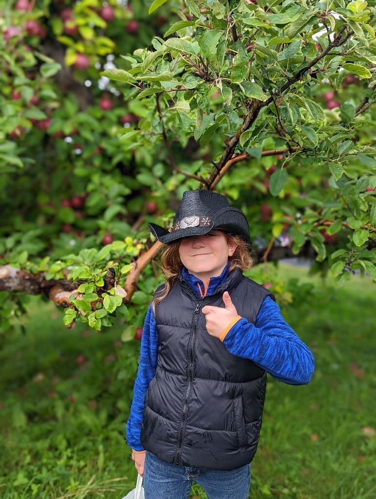 boy with hat in orchard 