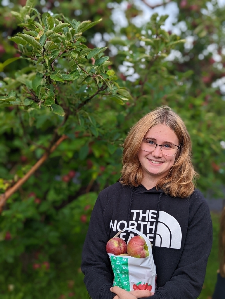 girl with glasses at the orchard