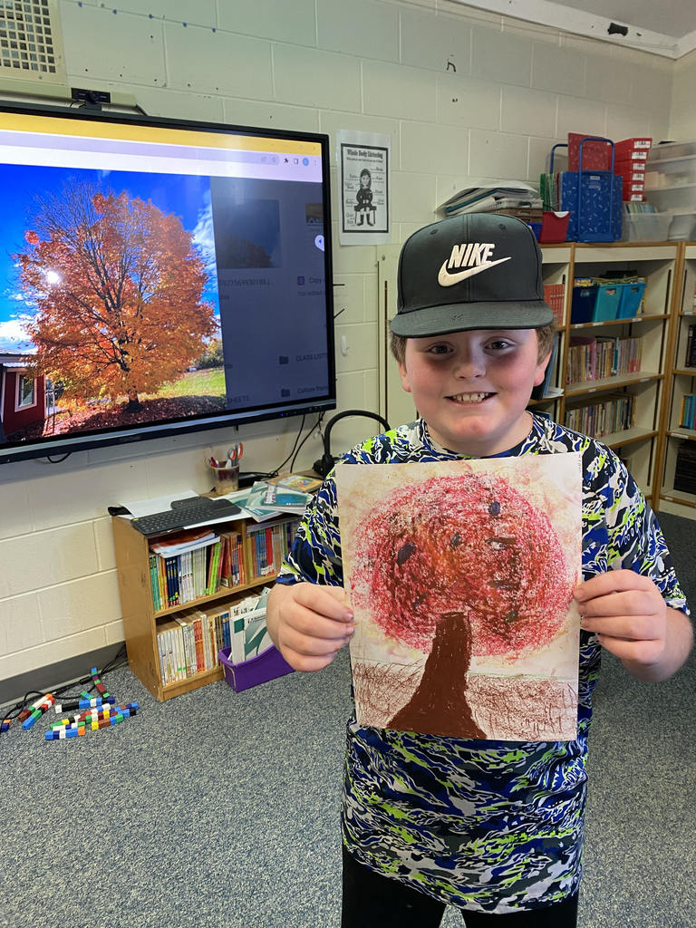 Student showing off art work