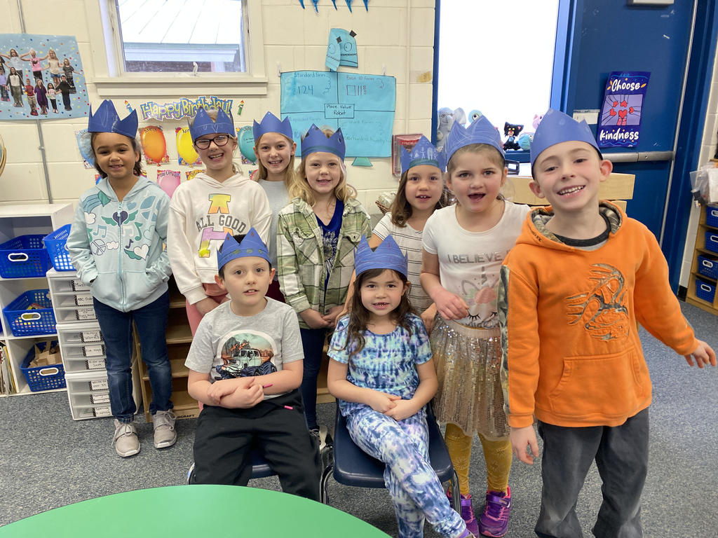 Students in classroom wearing crowns