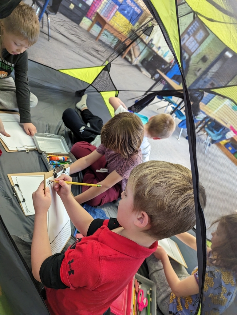 students writing in a tent in the classroom