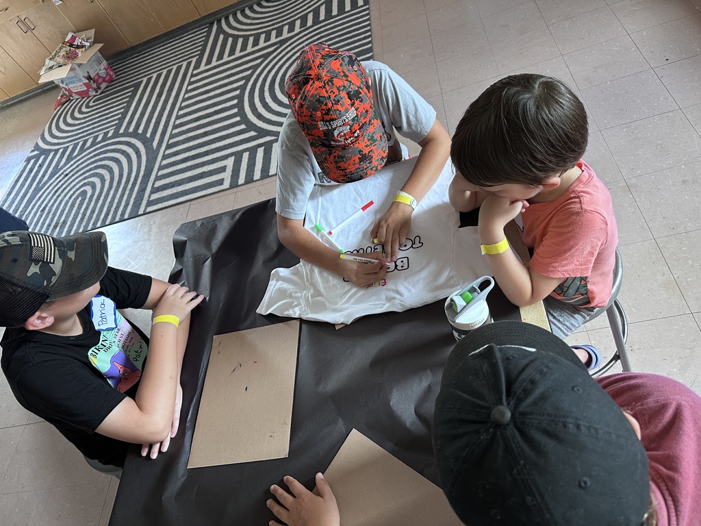 group of students coloring a t-shirt
