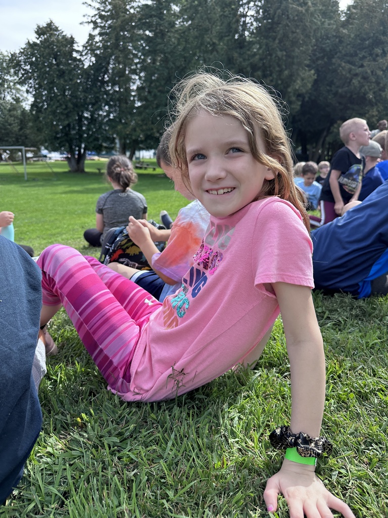 Student sitting outside on grass